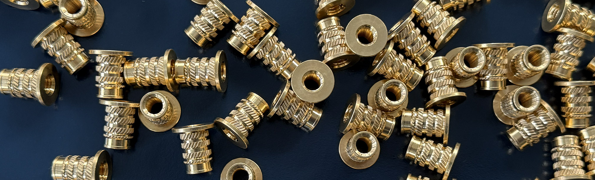 Brass Inserts on Blue Background